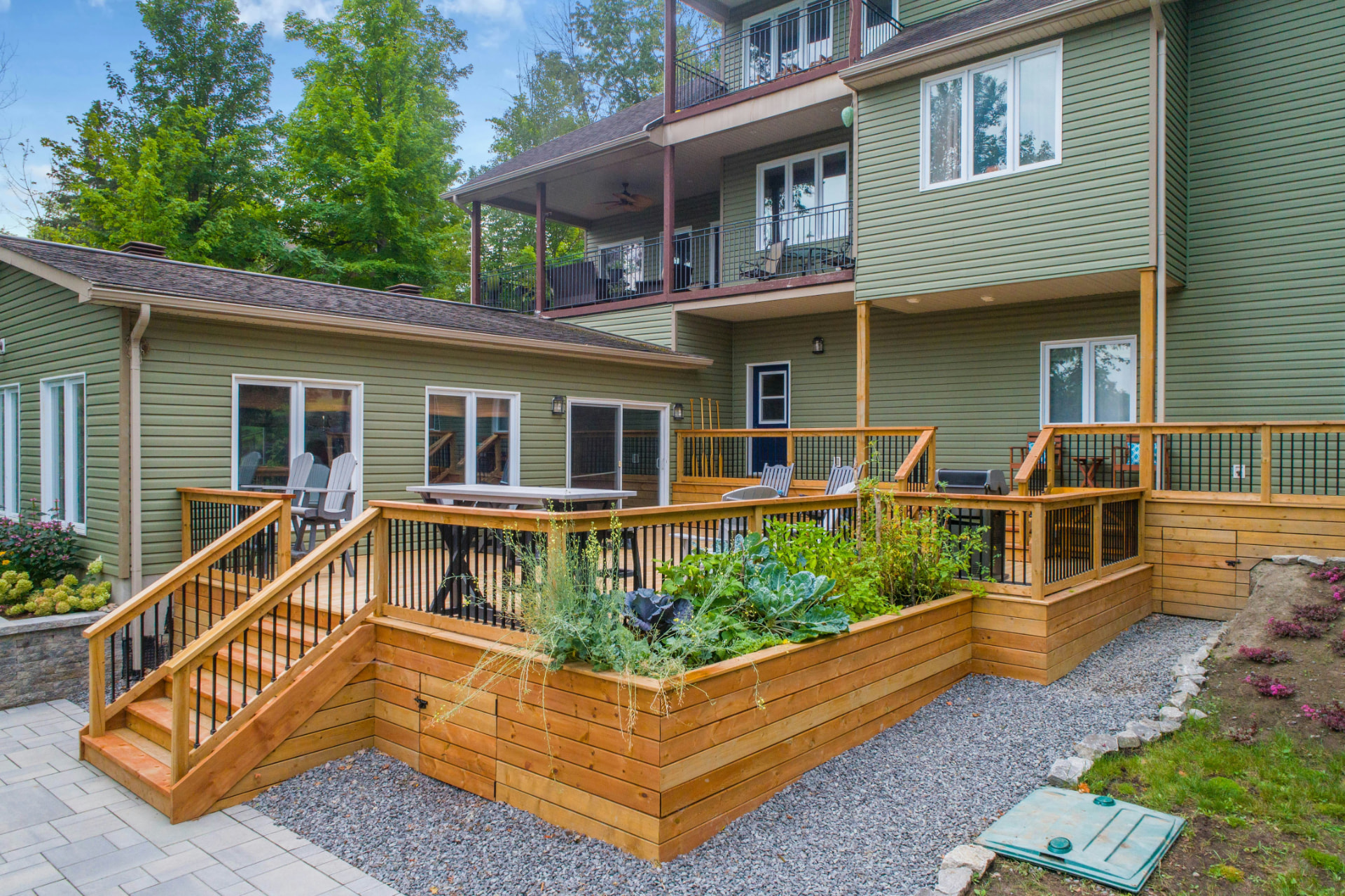 Multi-level cedar deck with stairs, skirting and built-in raised planter beds